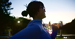 Woman, night and running with bridge in city for exercise, fitness or cardio workout in Japan. Active, female person or profile of runner enjoying late evening training on path in an urban town