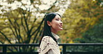 Walking, thinking or Asian woman in park for view or ideas in city of Japan culture for tourism. Girl, smile or happy Japanese person in urban town for sightseeing travel on outdoor holiday adventure