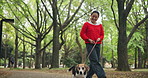 Walking, travel and Asian woman with dog in park with pet leash for fresh air, adventure and exercise. Happy, animal care and Japanese person with Beagle in nature for wellness, health and relax