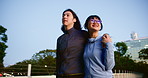 Japanese couple, walking and talking in city, care and hug together with happy partner on date. Asian man, woman and relationship outdoor on bridge for support, travel or connection for love at night