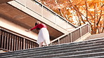 Ballet, dancer and Asian woman in city on stairs for performance, dancing and practice in town. Creative, entertainment and ballerina in Japan for elegant movement, balance and artistic talent