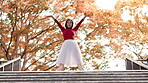 Japanese, woman and creative dance on park steps with balance, moving and public performance. Trees, dancer and autumn with Asian culture, tradition and celebration on city stairs with low angle