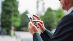 Hands, phone and businessman in town, travel and texting for networking, landmark and direction in city. Person, smartphone and outdoor on urban sidewalk with scroll, contact and mobile app in Japan