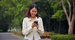 Japan, funny and woman with cellphone, walking and typing with meme, social media and network. Asian girl, outdoor and person in street, smartphone and joke with connection, nature and digital app