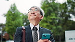 Business man, phone and reading in city on travel, contact or search for location on mobile app. Mature person, direction and smartphone on commute to work with notification, chat and map in Japan