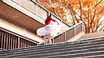 Woman, ballet and dancer with talent on stairs in city with spin, balance and rhythm in street. Person, dancing and steps for art with moving, concert and performance on urban sidewalk in Japan