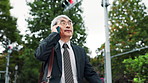 Phone call, travel and mature business Asian man in city for contact on commute, walking and trip. Professional, corporate and Japanese person on smartphone for communication, networking and talking