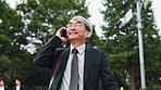 Phone call, city and mature Asian man travel for morning commute and talking, chat and speaking. Professional, corporate and Japanese person on smartphone for communication, networking and contact