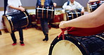 Japanese, hands and ribbon with drum or instrument for taiko tradition, culture or preparation for music. Closeup, musicians or people with sound, tool or wooden equipment for percussion in Japan