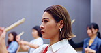 Drums, women and playing music on instrument for performance practice, festival rehearsal and talent. Taiko band, japanese people and drummer group with percussion in studio with sound entertainment
