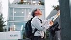 Business man, phone and vending machine in city with travel, shopping and mobile app for payment. Mature person, smartphone and cashless with fintech, commute and choice on urban sidewalk in Japan