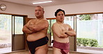 Face, sumo wrestling and men with competition, arms crossed and fighting with training. Portrait, people and fighters in studio, wellness and pride with traditional culture, athlete and Japanese