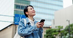 Woman, phone and thinking with walk in city, travel or search for buildings with low angle in street. Girl, person and smartphone on commute, tourism and mobile app for location on sidewalk in Japan