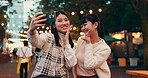 Friends, selfie and outdoor for street market, bonding and social media with celebration in Japan at night together. Women, memory and happy in Tokyo for culture, festival and community with travel