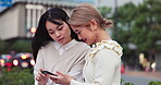 Japanese, happy and women with phone in city for communication, social media and reading gossip. Smile, people and relax with mobile of urban location, news notification and bonding together in Japan