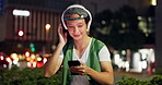 Man, headphones and phone at night in town, scroll website and streaming online for playlist. Male person, relax and outdoor music for peace in Japan, browse social media and internet for sound