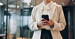 Business woman, hands and walking with phone at office for communication, online chatting or texting. Closeup, female person or employee on mobile smartphone for app, career or network at workplace