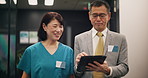 Nurse, doctor and walking with tablet in hospital for health management and staff service delivery. Medical administration, japanese people and digital policy for quality assurance or clinic schedule