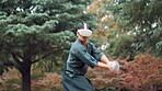 Aikido, technique and virtual reality with Japanese man in forest for metaverse exercise or training. Controller, equipment and VR headset with Samurai person outdoor in nature for culture or skill