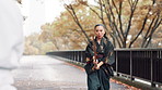 Wood, sword and Japanese woman in fight for martial arts, culture and traditional sports on bridge at park. Bamboo katana, samurai and practice training, duel or challenge partner to kenjutsu battle