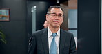 Walking, elevator and Japanese CEO in office for morning meeting for company finance report. Professional, manager and mature businessman in workplace corridor with smile for corporate career.