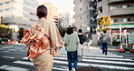 Woman, back or walking with kimono at pedestrian crossing in Tokyo city for travel or style. Japan, female person or clothing with stylish clothing for tradition, culture or heritage in an urban town