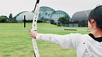 Archery, bow draw and training with woman in Japan for shooting game, challenge and target practice. Competition, arrow and weapon with sports gear and athlete in field for score, aim or bullseye