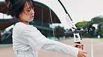 Archery, bow and Japanese woman in field for shooting game, challenge and target practice. Competition, arrow and draw weapon with sports gear and athlete training for score, aim or bullseye