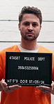 Criminal, police station and man with mugshot, arrest and thief with record, crime and identity frame. Portrait, person and prisoner with board, violations and public safety with legal photography