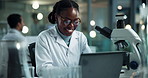 Scientist, black woman and microscope with laptop notes for research, experiment and medical chemistry. Chemical analysis, expert and smile with inspection for pharmaceutical study report success