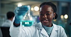 Scientist, black woman and chemical beaker shake with smile for chemistry, experiment and medical research. Microscope, analysis and expert with liquid inspection for pharmaceutical study success