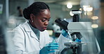 Scientist, black woman and chemical pipette with smile for chemistry, experiment or medical research. Microscope, sample analysis and expert with liquid inspection for pharmaceutical, pathology study