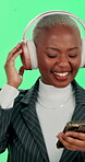 Smartphone, black woman and dancing with headphones on green screen for music, playlist and audio in studio. Female person, employee and happy on website, radio and streaming service on mockup space