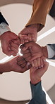 Teamwork, meeting and hands of business people fist pump for agreement, solidarity and support. Professional, corporate and low angle of workers for collaboration, partnership and working together