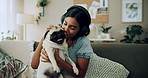 Happy woman, kiss and play with dog in home for love, care or listen to music on headphones. Pet, animal or friends together on sofa to support, connection or Indian girl scratch cute pug in adoption