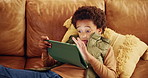 Learning, relax and tablet with black child on sofa in living room of home for education or development. Gaming, study and technology with African boy in apartment for online challenge or game