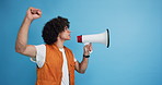 Man, bullhorn and protest with fist in studio, shouting and voice opinion to stop war by blue background. Person, loudspeaker and announcement for change, profile and call to action for human rights