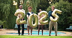 New year, 2025 balloon and friends in garden for party, festival celebration and holiday. Happy, dance and portrait of men and women with decorations for vacation, social event and fun in backyard