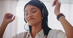 Woman, headphones and dance in home, living room and happy for freedom, music or listening to sound. Girl, smile and movement for audio, streaming subscription and idea or excited with freedom