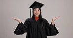 Offer, mockup space and face of graduate in studio for options, decision or choice with balance. Happy, portrait and Japanese woman with scale hand gesture for academic graduation by gray background.