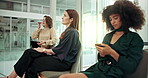 Recruitment, waiting room and group of business women check time for interview, schedule or typing on phone. Hiring, candidates and queue in office for career opportunity, job search and cv on tablet