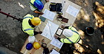 Above, men and engineer on construction site with paper, urban development and project management with tablet. Architect team, blueprint and talking at equipment for building renovation with planning