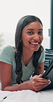 Woman, face and tablet with smile in hotel room, travel and luggage with scroll, application and trip planning. Person, girl and digital touchscreen for contact, notification or happy on bed in India