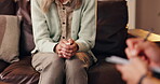 Therapist, patient and hands in consultation for mental health, discussion and recovery support for anxiety. Therapy, psychologist and person on sofa for counseling, share trauma, notes in session