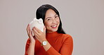Woman, studio and happy with piggy bank for saving plans, money and investment on white background in Japan. Female person, face and smile or satisfied in confidence with pride for profit and budget