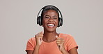 Black woman, studio and  smile with dancing on headphones for streaming music on white background. Female person, isolated and happy or excited with online playlist, audio and song for entertainment
