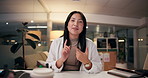 Happy, asian woman and explanation with video call at night for presentation, webinar or online communication. Portrait, female person or talking with smile or POV for virtual meeting at office desk