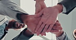 Business people, hands together and meeting below with team for motivation, mission or collaboration at office. Low angle, group or employees piling in unity for solidarity, agreement or coordination