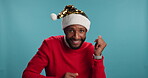 Christmas, dancing or face of man in studio with celebration, party or smile on blue background. African person, portrait or excited model with rhythm or event with joy, Xmas hat or winner or holiday
