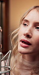 Microphone, woman singing and musician in recording studio for audio production, creative performance or talent. Music artist, girl or professional singer with sound, pop or broadcast voice for album